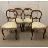 A set of four Victorian walnut dining chairs