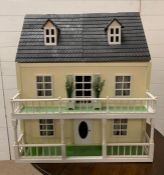 A doll house with balcony and attic along with contents