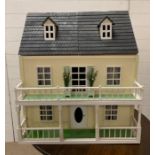 A doll house with balcony and attic along with contents