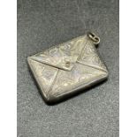 A silver, marked 925 envelope style stamp holder.
