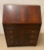 A reproduction bureau with drop down slope opening to pigeon holes and drawers