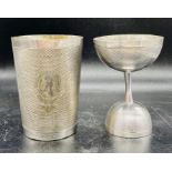 A white metal beaker and cup, machine tooled with blank cartouche.