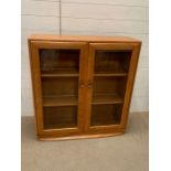 Am Ercol glazed to door cabinet (H100cm W92cm D28cm)