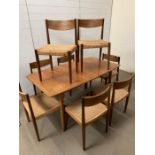 A McIntosh teak dining room table and seagrass chairs, stamped Danish (Chairs AF) (H74cm W148cm