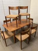 A McIntosh teak dining room table and seagrass chairs, stamped Danish (Chairs AF) (H74cm W148cm