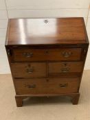 A mahogany bureau on bracket feet, opening to reveal drawers and pigeon holes (H103cm W76cm D47cm)