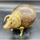 An antique bell AF in the form of a pig in wood and brass.