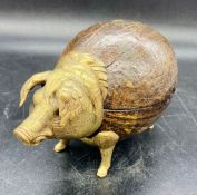 An antique bell AF in the form of a pig in wood and brass.