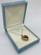 A Hallmarked 9ct gold heart shaped locket on fine necklace