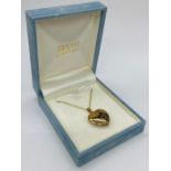 A Hallmarked 9ct gold heart shaped locket on fine necklace