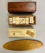 A selection of boxed dominoes and cribbage board
