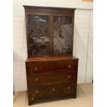 A Regency mahogany secretary bookcase, upper section with two adjustable shelves enclosed by a