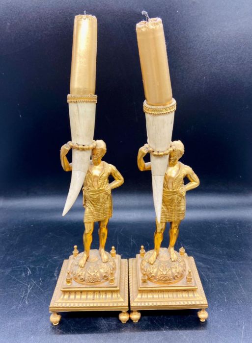 A pair of Delt and brass holders on square bases and bracket feet
