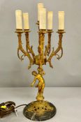 A six branch brass candelabra, in the form of male partially clad supporting the scrolling