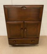 An Ercol bureau or cabinet