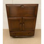 An Ercol bureau or cabinet