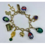 A 9ct gold charm bracelet with a range of charms including four enamel eggs and various hallmarked