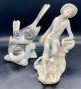 Two pieces of Lladro two birds sitting on a tree and a boy with his dog