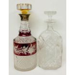 Two cut glass decanters, one with a silver collar
