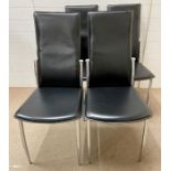 A set of four black chairs with chrome legs