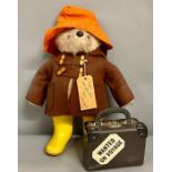 A Paddington Bear with original suitcase and contents and Wellington boots (H46cm)