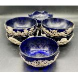 A Set of six silver Chinese bowls with blue glass liners, various patterns.