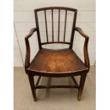 A Sheraton mahogany dining armchair with square back, four reeded vertical splats and solid seat