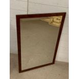A contemporary mirror with walnut style frame (63cm x 95cm)