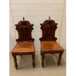 A pair of Victorian hall chairs, shield carved backs on turned legs