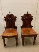 A pair of Victorian hall chairs, shield carved backs on turned legs