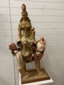 An oriental lady sat on a mythical beast possibly plaster (H130cm W51cm D32cm) (wooden plinth