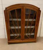 An Art Deco style display cabinet with glazed doors (H115cm W92cm D28cm)