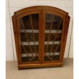 An Art Deco style display cabinet with glazed doors (H115cm W92cm D28cm)