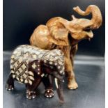 Two decorative elephants one in wood and the other cast metal.