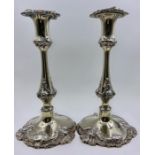 A pair of silver plated, weighted single candlesticks