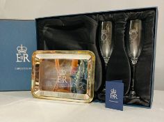 A pair of Champagne flutes and a silver plated tray given as a gift to a member of the Royal