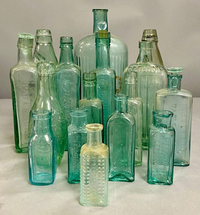 A large collection of turquoise glass bottles