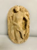 A carved wooden figural plaque or sculpture