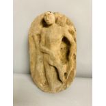 A carved wooden figural plaque or sculpture