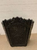 A carved fire guard