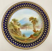 A mid 19th Century hand decorated Worcester style plate with blue and gilt border and lake scene to
