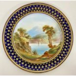 A mid 19th Century hand decorated Worcester style plate with blue and gilt border and lake scene to