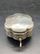 A small silver jewellery box on three legs, hallmarked for Birmingham 1908 by Deakin & Francis Ltd