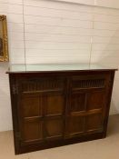 Oak panels converted into a tall cupboard with shelves inside and mirrored glass sheet to top (