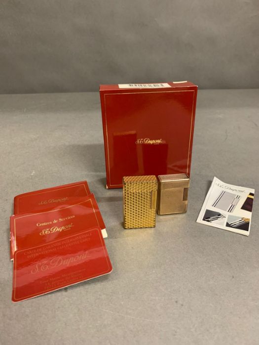 Two Vintage Dupont lighters with supporting paperwork.