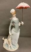 A Lladro lady with shawl and dog