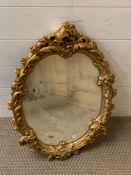 A Rocco style mirror with gilt plaster frame (43cm x 60cm)