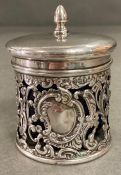 A silver lidded pot with pierced foliate design and blue glass liner by Levi & Salaman, hallmarked