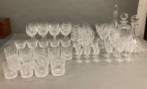 A large collection of crystal cut glass to include three decanters, brandy, sherry, wine etc glasses