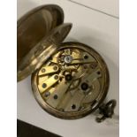 A small silver pocket watch.